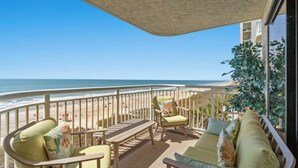 A balcony with a view of the beach, furnished with chairs and a table. - Windemere 605 -Oceanfront 3BR/2BA-Indoor Pool (North Myrtle Beach)