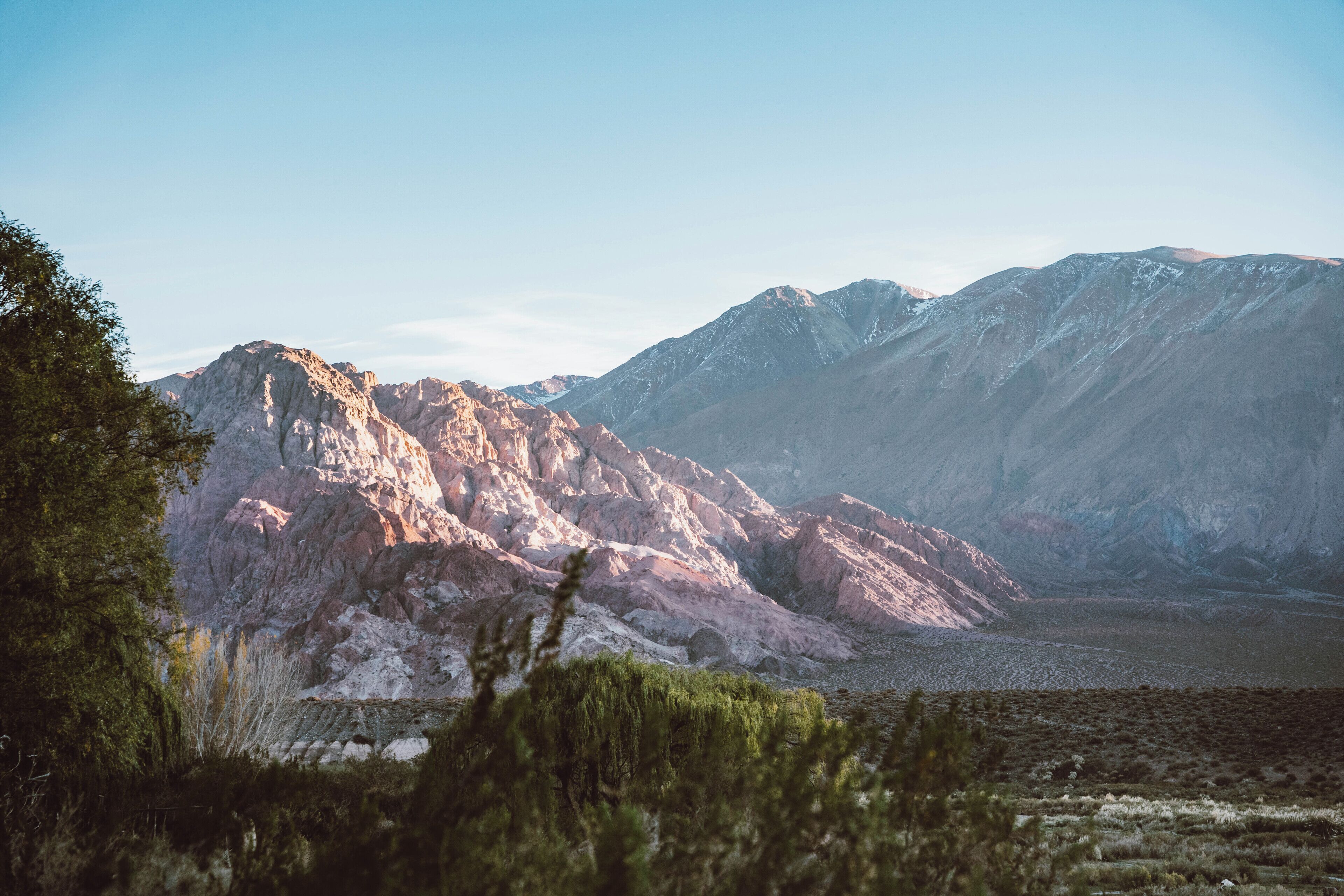 A mountainous landscape with rocky terrain and sparse vegetation.