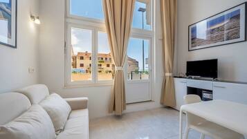 Premium Apartment, Courtyard View | Living area | Flat-screen TV