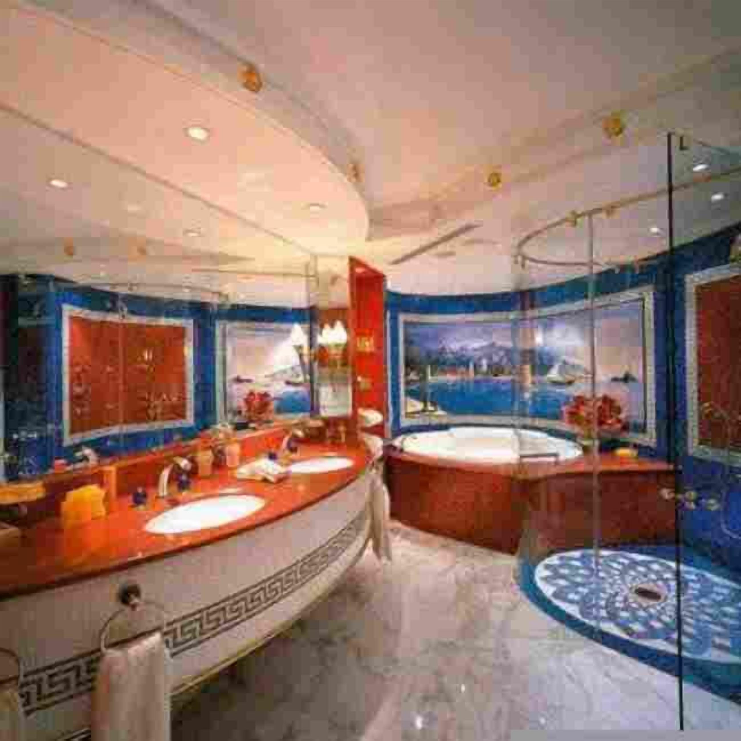 A luxurious bathroom with a large bathtub, two sinks, and a large mirror.