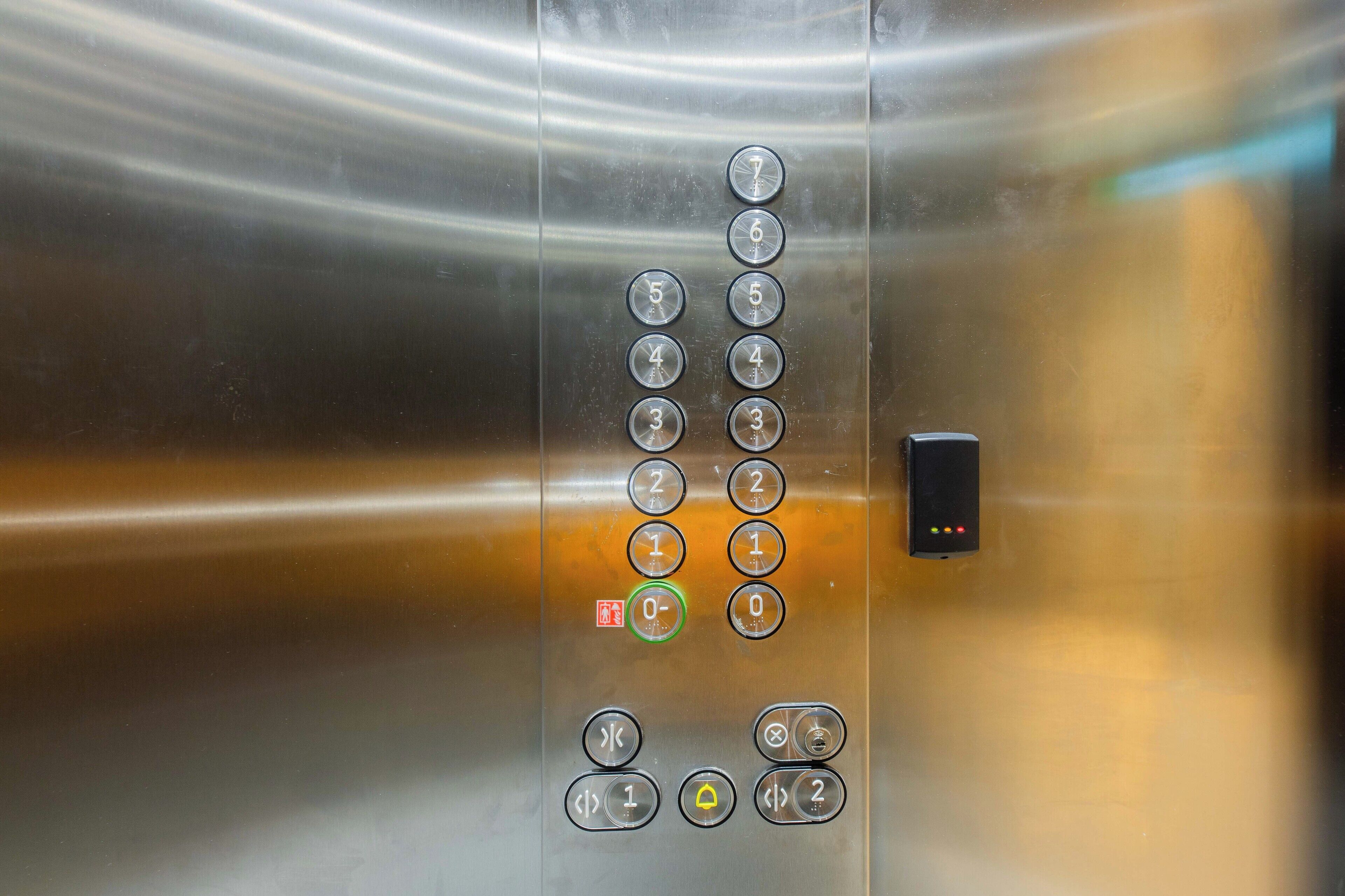 An elevator control panel with buttons for floor selection and emergency stop.