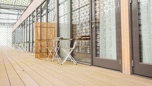 A modern hotel interior with a long corridor, large windows, and a wooden floor. - Alphabet Apartments Brede Hilledijk (Rotterdam)