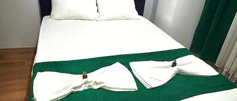 Premium bedding, desk, laptop workspace, blackout drapes