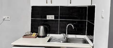 Mini-fridge, cookware/dishes/utensils, cleaning supplies, paper towels