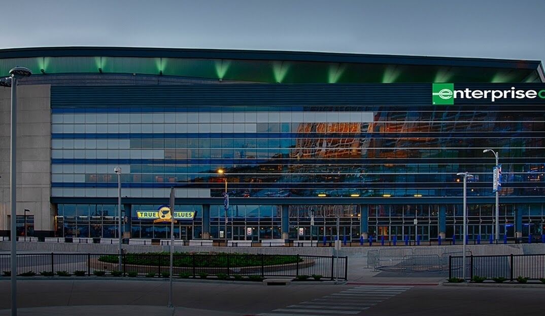 A modern building with a glass facade and a sign for "Enterprise."