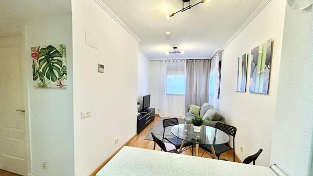 A modern apartment with a dining area, a living room, and a staircase. - Valleca Tren Sierra Guadalupe 1 (1 bedroom apartment) (Madrid)