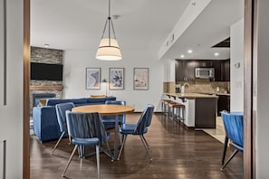 A modern kitchen with dark cabinets, a microwave, and a countertop.