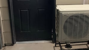 A black door with a handle and a white air conditioning unit beside it. - 1,2,3,4 Escape comfort & style. You'll love it!" (Las Vegas)