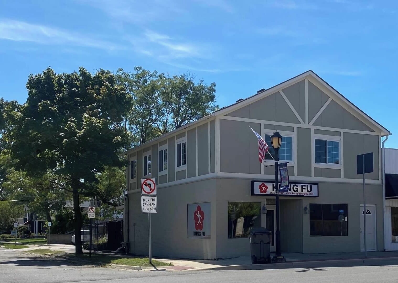A two-story building with a sign reading "KUNG FU" and a no parking sign.