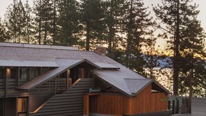 A modern building with a sloped roof and wooden exterior, featuring a 'Bienvenido' sign. - evo Hotel Tahoe City (Tahoe City)