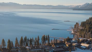 A lakeside resort with multiple buildings, a dock, and snow-covered surroundings.