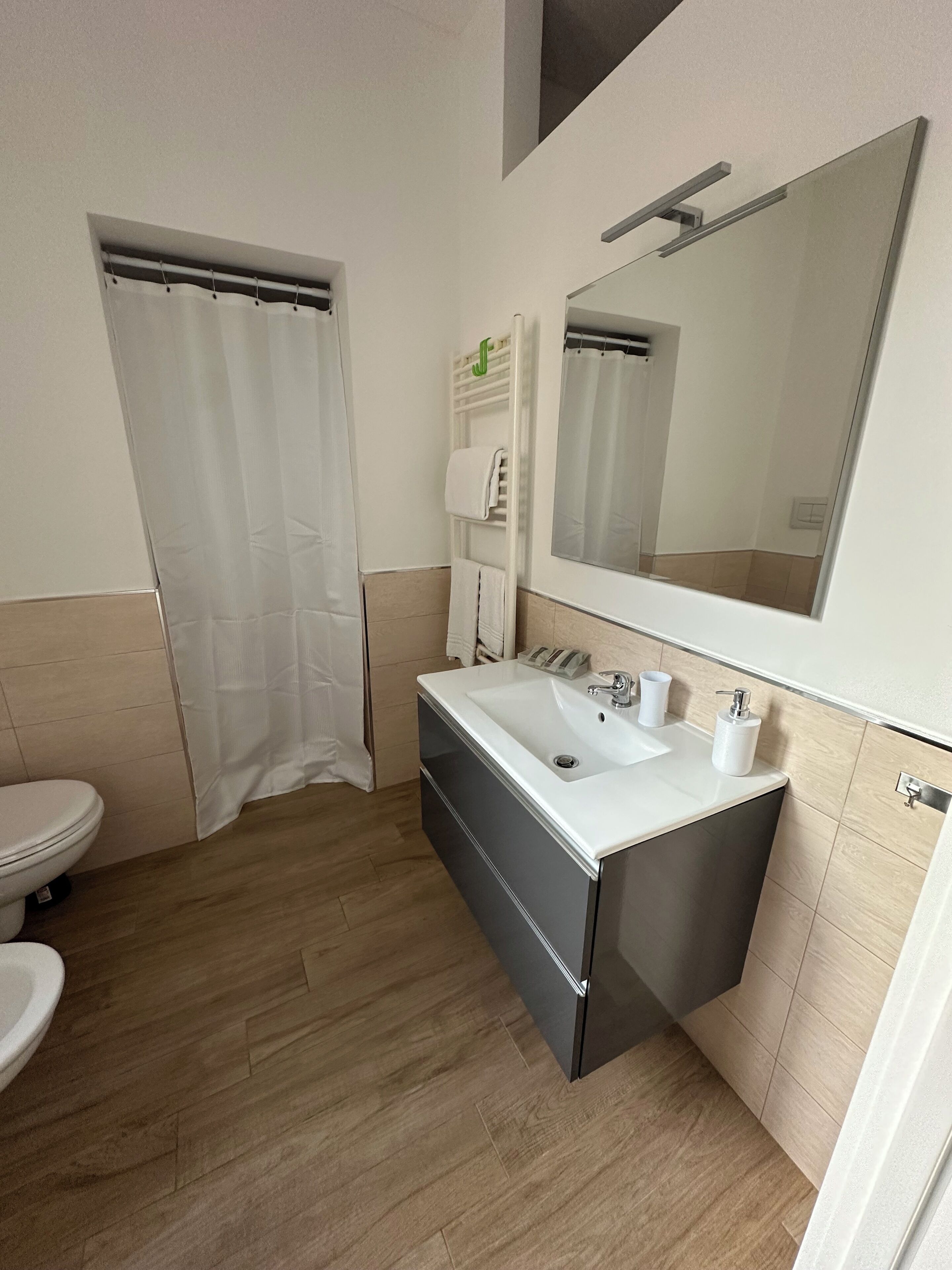 A modern bathroom with a toilet, sink, and shower area.