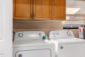 A laundry area with two dryers and a water heater. - Screened Heated Pool, 15 Min to Beach | 4BR Sleeps 10, Largo (Largo)