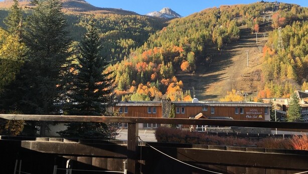 A hotel with a view of a mountainous landscape and autumn foliage. - Chantemerle T2, 49m2, south-facing,   (Saint-Chaffrey)