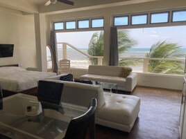 Luxury Suite, Beach View | Living area | 42-inch LED TV with cable channels