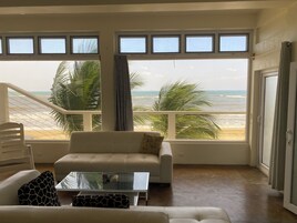Luxury Suite, Beach View | Living area | 42-inch LED TV with cable channels