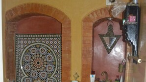 A bathroom with a tiled floor, a sink, and a mirror. - Accommodation decorated with Moroccan craftsmanship (Rabat)