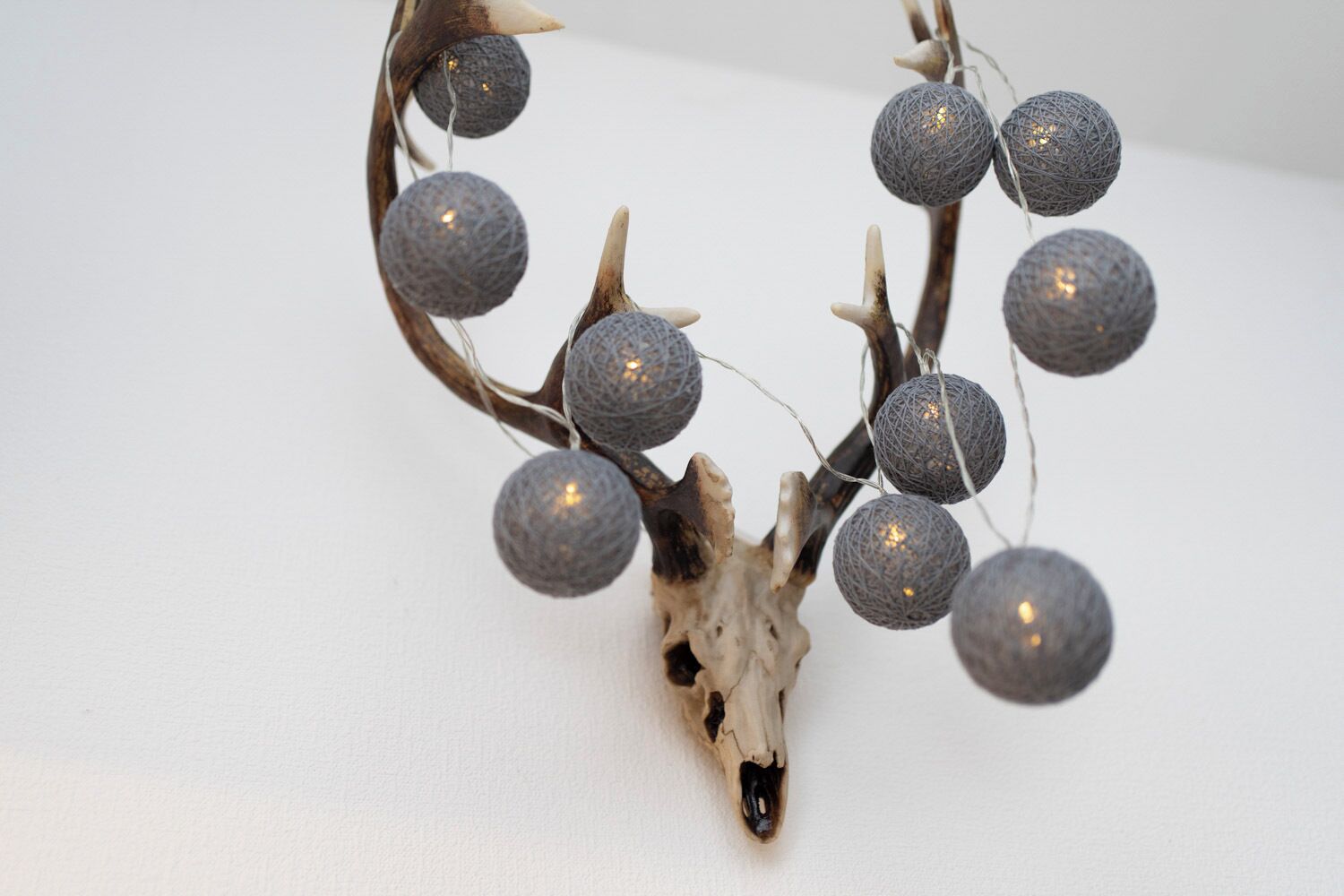 A decorative arrangement with spherical ornaments and a natural branch.