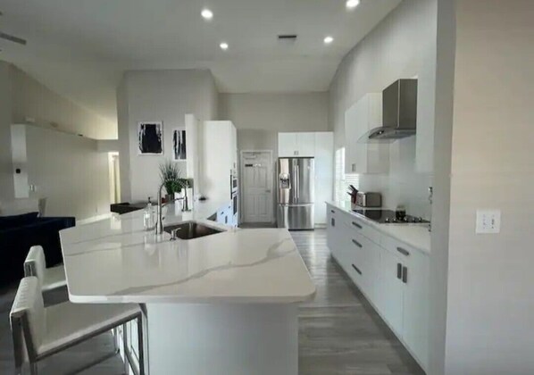 Enjoy cooking in this well-equipped kitchen with a central island, sink, and oven.