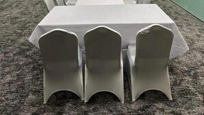 A conference room with a long table, white chairs, a television, and a decorative wooden panel. - hotel alfal alshemaly (Duba)