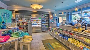 A well-lit store with shelves stocked with snacks, beverages, and a variety of items. - Emerald of the Gulf - beachfront condo at Portofino Island resort, great views! (Pensacola Beach)