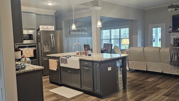 A modern kitchen with a central island, built-in appliances, and pendant lighting. - Masters Tournament Rental 2027 (Graniteville)