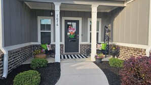 A house with a front porch, a brick wall, a welcome sign, and a mailbox. - Masters Tournament Rental 2027 (Graniteville)