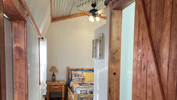 A narrow hallway with wooden walls and a sloped ceiling. - Charming 2-bedroom cabin with WiFi and AC in Licking (Licking)