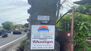 A hotel signboard with the name 'CANDRA ADIGRAHA' and catering services contact number. - Hotel Candra Adigraha (Denpasar)
