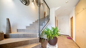 Eine moderne Treppe, ein Blumentopf und ein Wanddekor.