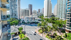 A high-rise building with multiple balconies and a parking area. - Royal Aloha by Tropical Escapes Realty (Honolulu)