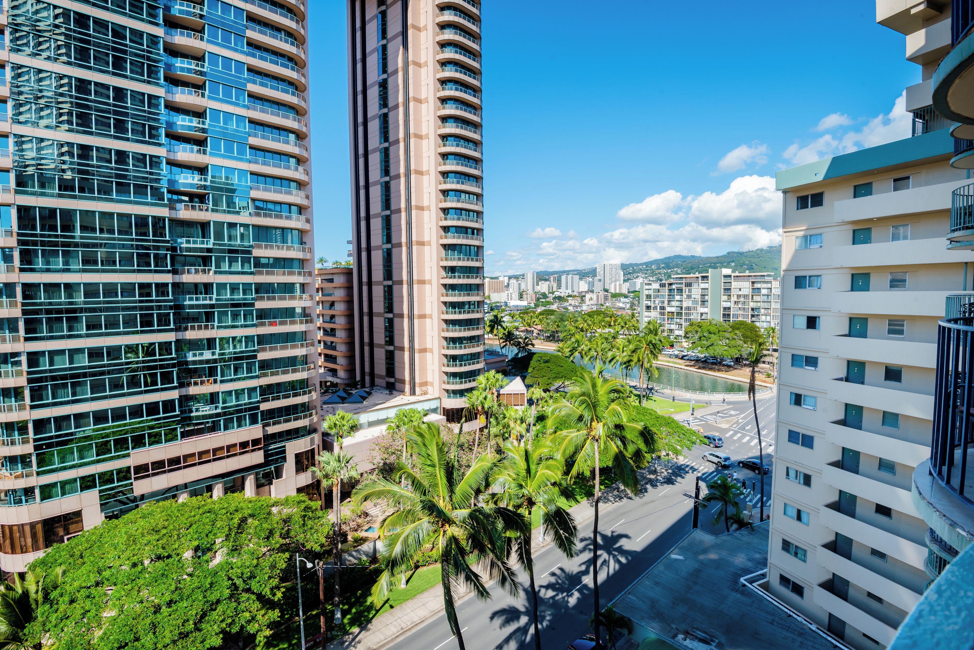A modern high-rise building with multiple floors, large windows, and balconies.