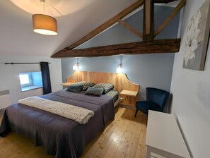 A bedroom with a bed, bedside tables, a chair, a window, and a ceiling light. - Holiday Home 'La Bonne Chauffe - Serpentin' with Shared Pool, Private Terrace and Wi-Fi (Verrières)