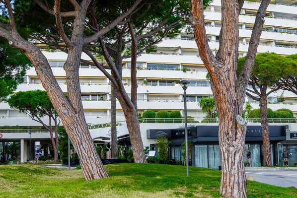 A multi-story building with a modern architectural style, featuring balconies and a flat roof.