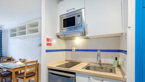 A compact kitchen with a microwave, sink, and dishwasher. - Studio Apartment 'Enjoy French Riviera - Fame Marina' with Wi-Fi and Air Conditioning (Villeneuve-Loubet)