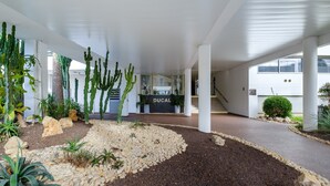 A modern building with a reception area labeled 'DUCAL,' featuring a cactus garden and a stone pathway. - Studio Apartment 'Enjoy French Riviera - Fame Marina' with Wi-Fi and Air Conditioning (Villeneuve-Loubet)