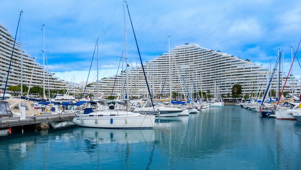 A marina with multiple cruise ships docked, a calm water body, and a clear sky. - Studio Apartment 'Enjoy French Riviera - Fame Marina' with Wi-Fi and Air Conditioning (Villeneuve-Loubet)