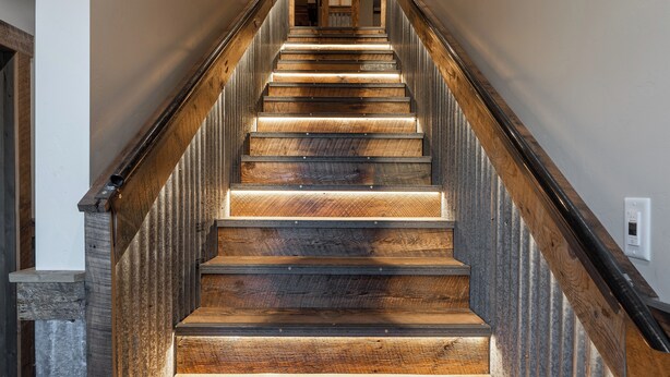 A wooden staircase with a handrail, leading to an exit sign at the top. - Escape to The Adventure Inn Yellowstone- Absaroka, just a minute from the park! (West Yellowstone)