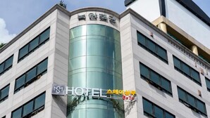 A modern hotel building with a glass facade and a sign indicating it is a hotel. - STAY SANGMU (Gwangju)