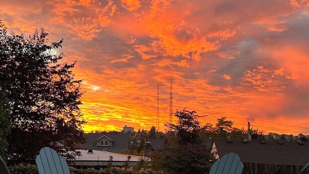 A sunset view with two Adirondack chairs and a fire pit in a gravel area. - Charming Madrona Stay • Walk to Lake & Cafes, Shops, A/C • Parking (Seattle)