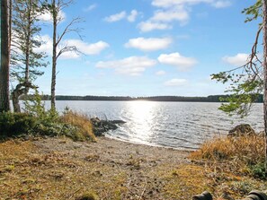 A lakeside view with trees and a clear sky. - Rehviranta by Interhome (Kuopio)