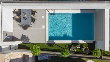 Seasonal outdoor pool, open 9:00 AM to 9:00 PM, pool loungers