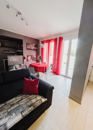 Apartment, Balcony | Living area | 32-inch flat-screen TV with digital channels