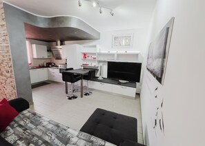 Apartment, Balcony | Living area | 32-inch flat-screen TV with digital channels