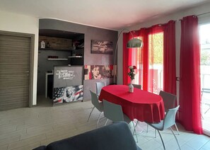 Apartment, Balcony | Living area | 32-inch flat-screen TV with digital channels