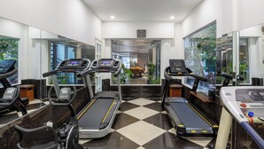 A modern gym with treadmills, a stationary bike, and a rowing machine. - A25 Premium Hotel - 65G Nguyen Thai Hoc (Ho Chi Minh City)