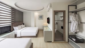 A modern hotel room with a large bed, bedside tables, a TV, a mirror, and a robe rack. - A25 Premium Hotel - 65G Nguyen Thai Hoc (Ho Chi Minh City)