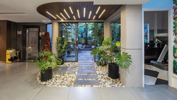 A modern hotel lobby with a stone pathway leading to an outdoor area. - A25 Premium Hotel - 65G Nguyen Thai Hoc (Ho Chi Minh City)