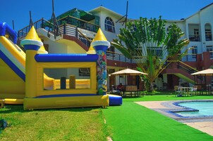 An inflatable play area with slides and a pool.