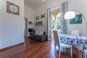 Apartment, Balcony, City View | Living area | 32-inch flat-screen TV with cable channels